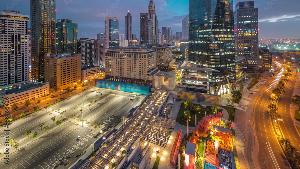 Fototapeta premium Dubai International Financial district aerial night to day timelapse. Panoramic view of business office towers.