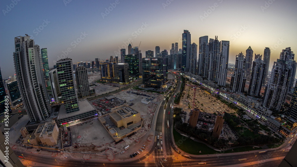 Panoramic skyline of Bay Avenue with modern towers residential development in Business Bay aerial day to night timelapse, Dubai