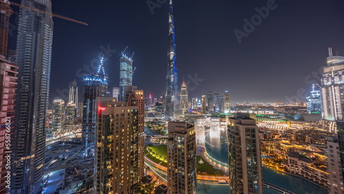 Dubai Downtown cityscape with tallest skyscrapers around aerial night timelapse.