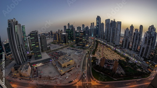 Panoramic skyline of Bay Avenue with modern towers residential development in Business Bay aerial day to night timelapse  Dubai