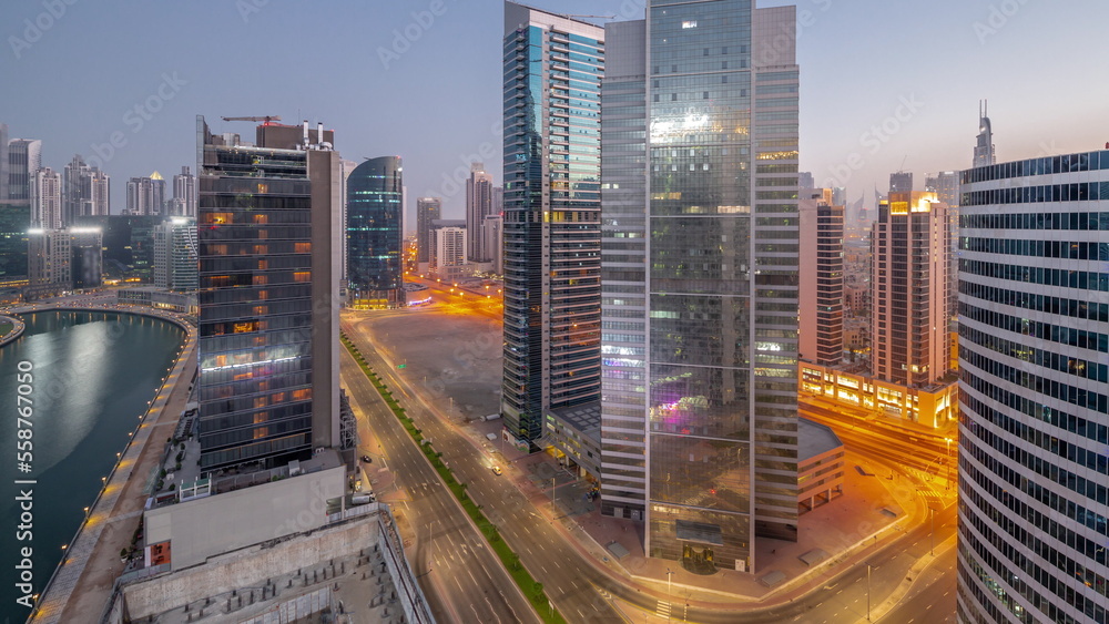 Obraz premium Cityscape of skyscrapers in Dubai Business Bay with water canal aerial night to day timelapse