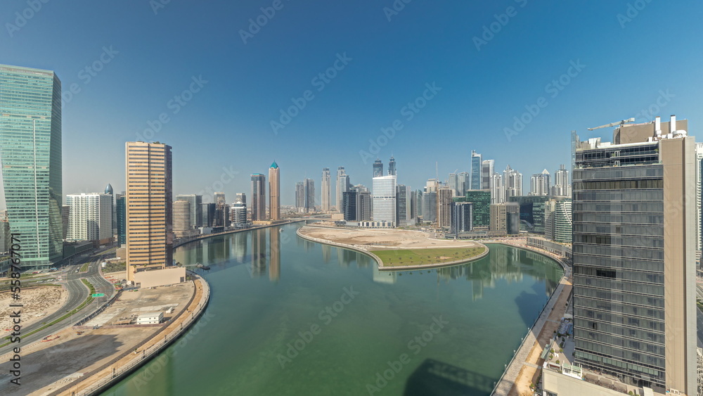 Cityscape skyscrapers of Dubai Business Bay with water canal aerial timelapse.