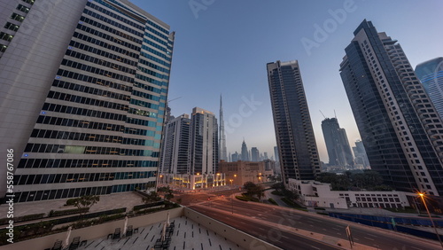 Aerial panoramic looking up view to Dubai downtown and difc skyscrapers night to day timelapse.