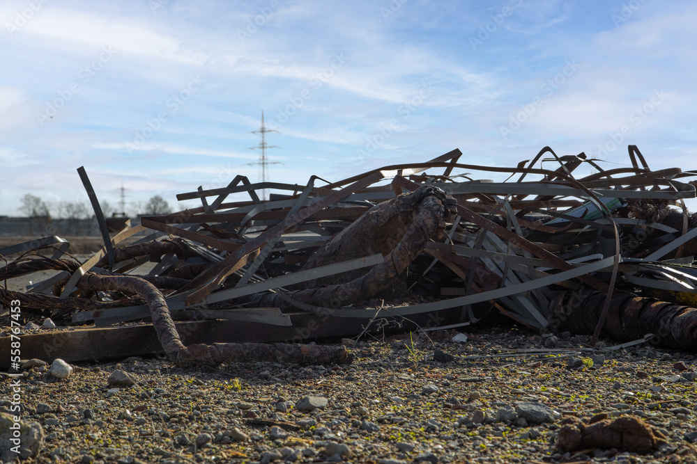 heap of garbage and trash of metal and junk lie on ground in nature as mound of scrap is litter and environmental pollution