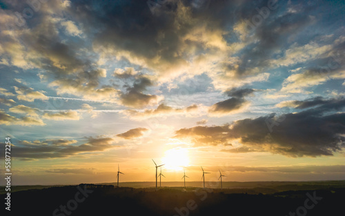 Wind turbines under the big sky at sunset
