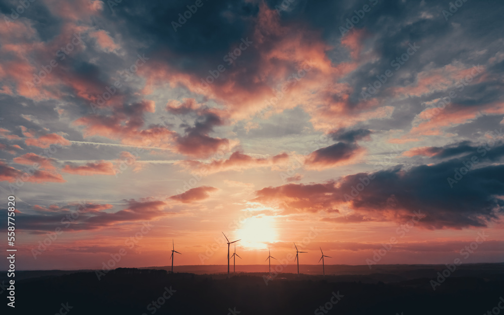 Wind turbines under the dramatic sunset sky