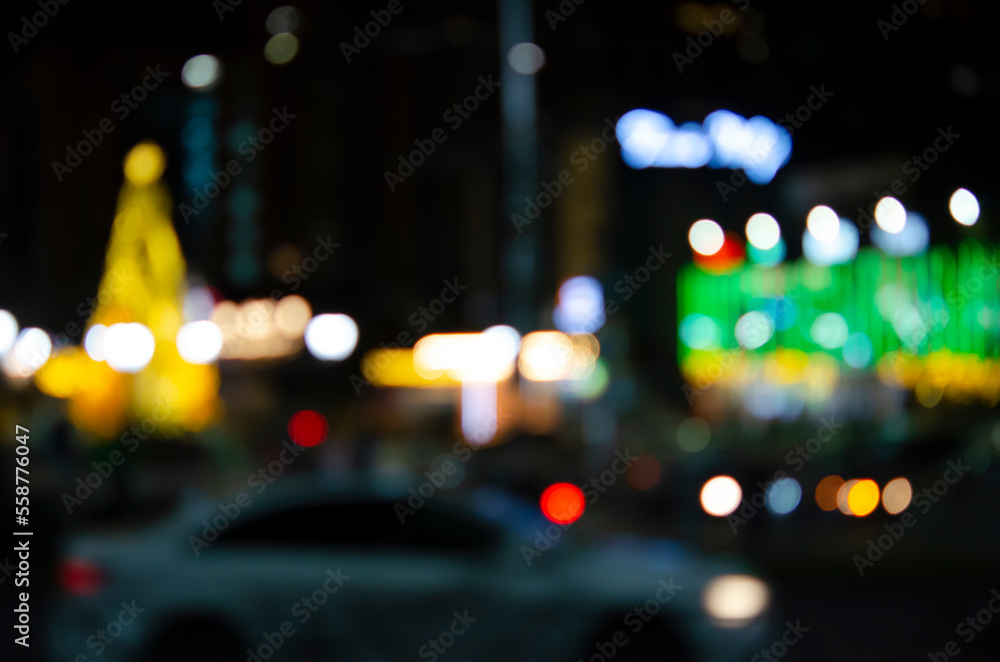 Night cityscape without focus. Blurred street background with illumination and bright lights. Neon illumination of the evening city.