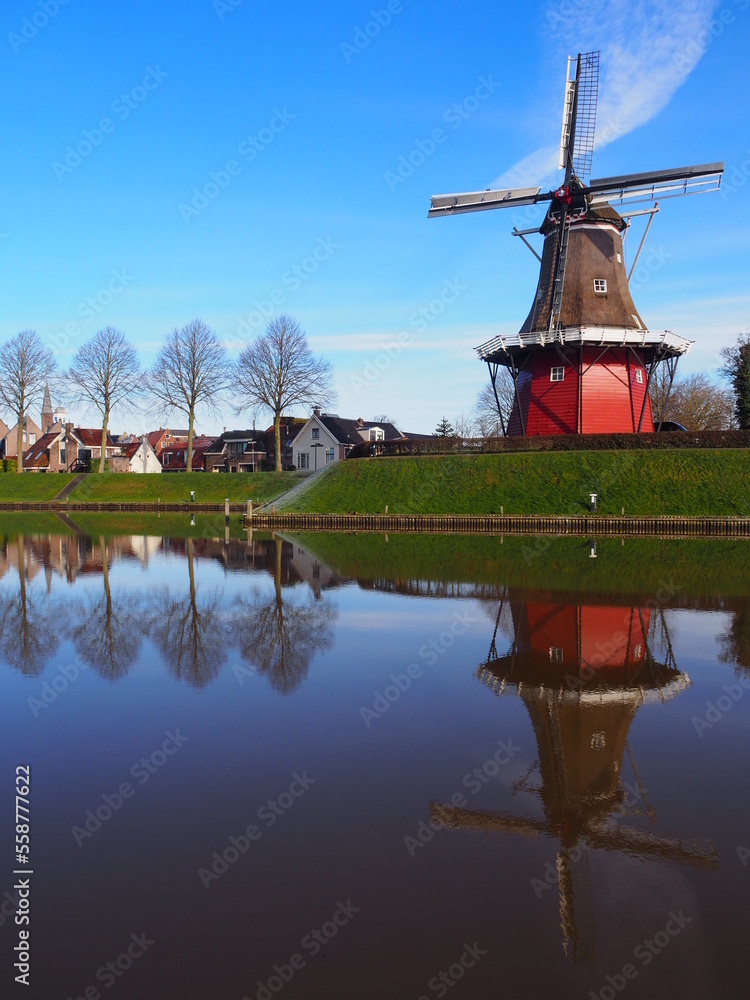 Windmill in dokkum sitting at the water. 