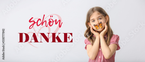 Cute little girl with butterfly on light background with text DANKE SCHON