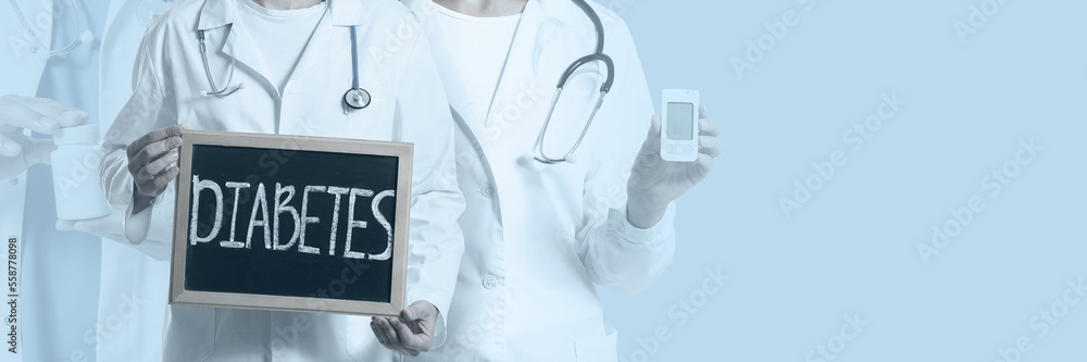 Doctors holding chalkboard with text DIABETES, pills and glucometer on light background with space for text. Banner for design Doctors holding chalkboard with text DIABETES, pills and glucometer on light background with space for text. Banner for design