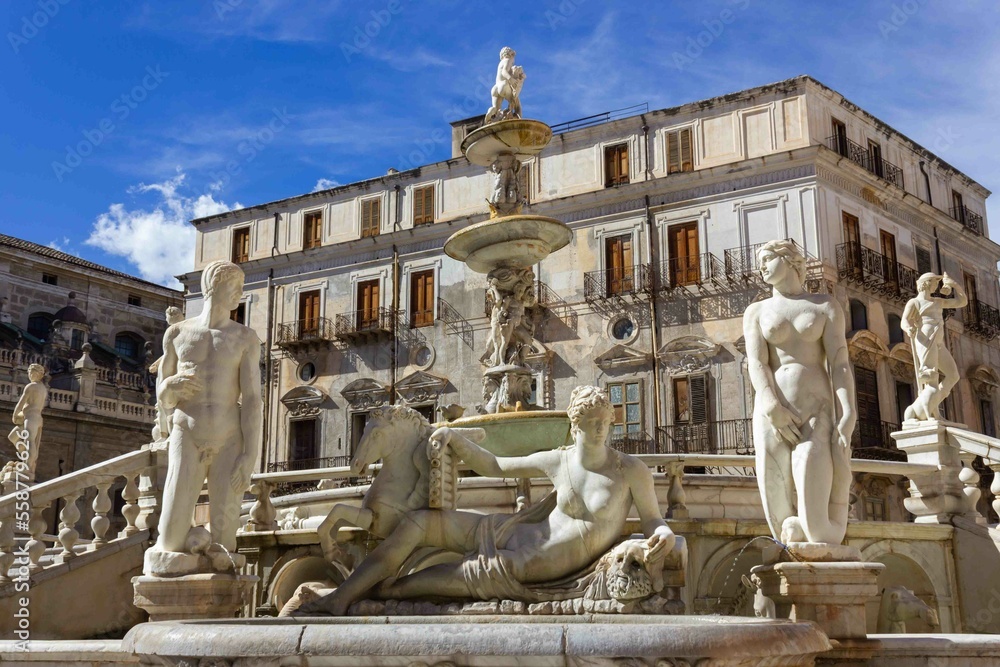 Marble statues of women and men in a fountain in italy