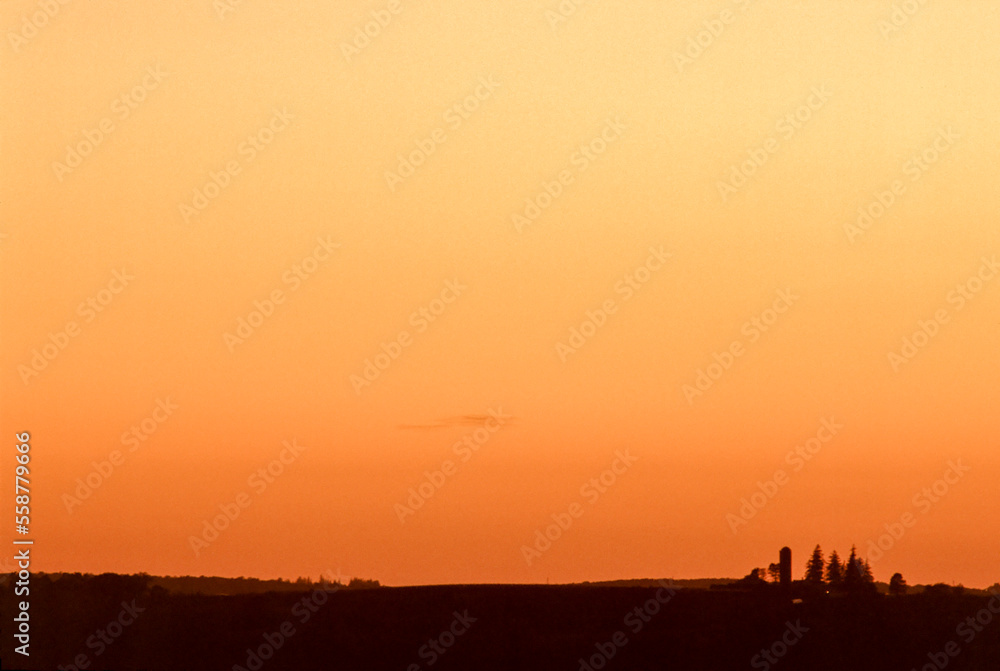 Orange rural Iowa landscape silhouette.