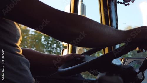 Wallpaper Mural Unrecognizable man holding his hands on steering wheel and driving a truck at country road on summer day. Truck driver rides to destination. Inside truck cab. Side Bottom view Slow motion Close up Torontodigital.ca