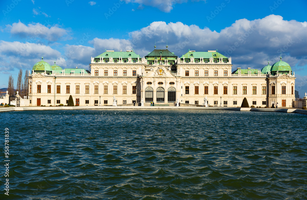 Scenic view of historic Belvedere complex with impressive baroque building of upper palace and water basin in Vienna, Austria on sunny winter day