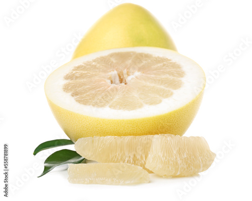 Whole and cut sweet ripe pomelo fruits with slices on white background photo