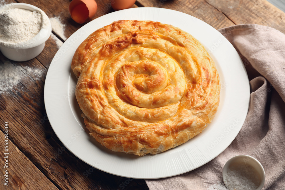 Plate with delicious cheese pie on wooden table Plate with delicious cheese pie on wooden table