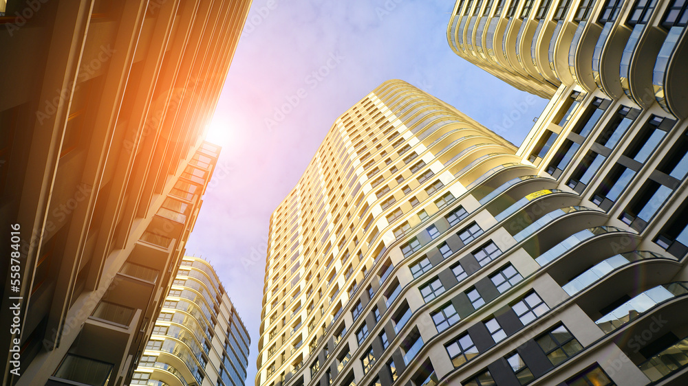 The narrow passage between modern residential buildings. Walls of high-rise apartment buildings and a narrow strip of sky between them. Modern urban living districts. Bottom view.
The narrow passage between modern residential buildings. Walls of high-rise apartment buildings and a narrow strip of sky between them. Modern urban living districts. Bottom view.