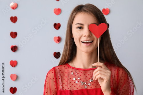 Young woman with paper hear...