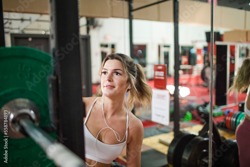 Woman preparing barbell in gym photo