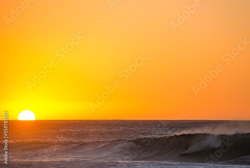 Catching one last wave before the sun goes down photo