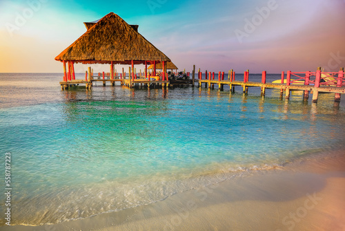 Fototapeta Naklejka Na Ścianę i Meble -  Tropical paradise, sand beach in caribbean with palapa and pier, Cancun, Mexico
