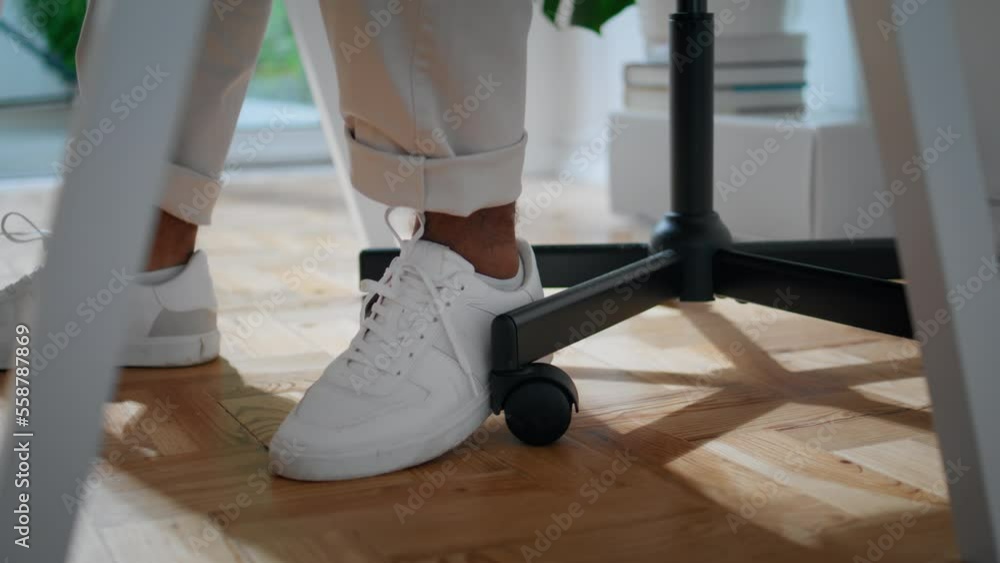 Modern student legs moving chair indoors closeup. Contemporary man feet desk Modern student legs moving chair indoors closeup. Contemporary man feet desk