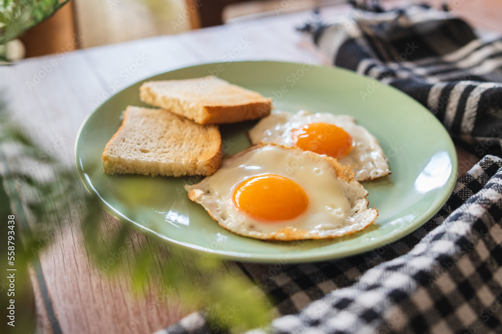 A top down and side view of eggs on the plate with toast bread on the side for breakfast clean meal healthy food A top down and side view of eggs on the plate with toast bread on the side for breakfast clean meal healthy food
