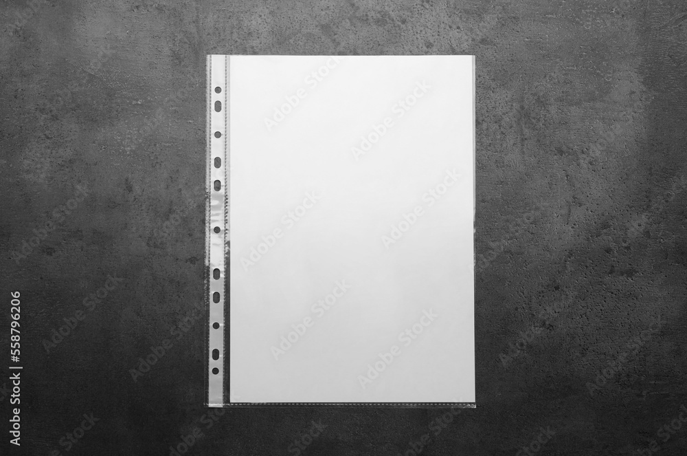 Punched pocket with paper sheet on grey background top view Punched pocket with paper sheet on grey background top view