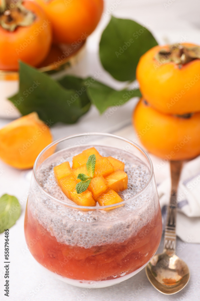 Delicious dessert with persimmon and chia seeds on table Delicious dessert with persimmon and chia seeds on table