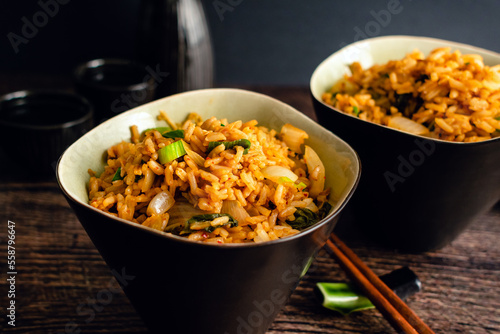 Kimchi Fried Rice With Chopsticks Next to the Bowls  Two bowls of Korean kimchi bokkeumbap made with fermented cabbage