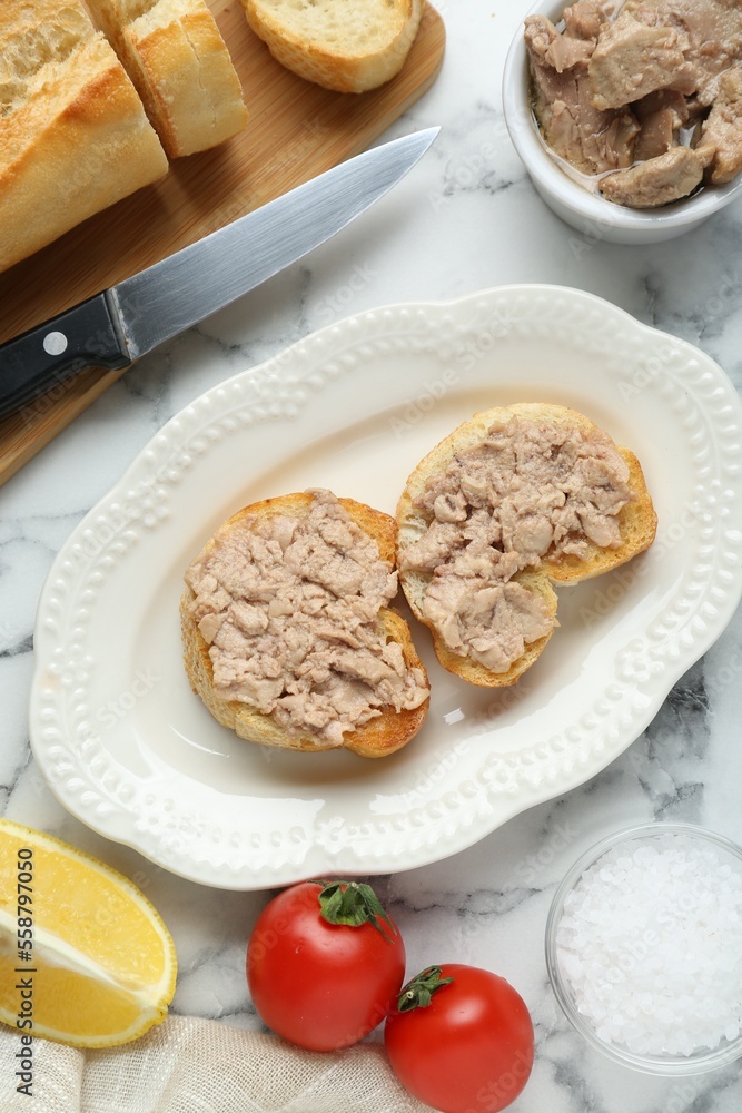 Tasty sandwiches with cod liver on white marble table, flat lay Tasty sandwiches with cod liver on white marble table, flat lay