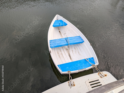 A dinghy in the water behind a boat.  photo