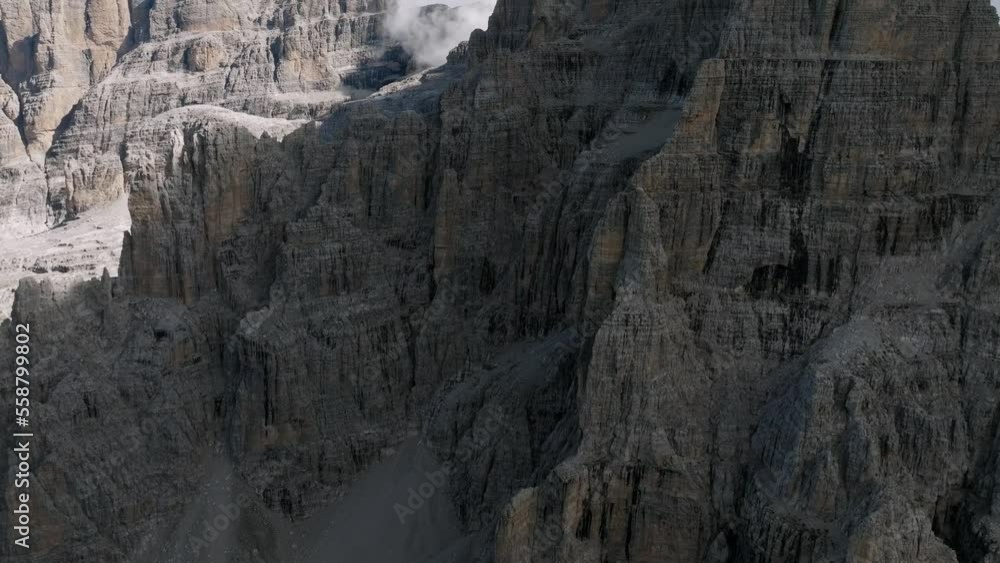 Epic drone shot of rocky mountain face wall during sunny day in Italian Dolomites Epic drone shot of rocky mountain face wall during sunny day in Italian Dolomites