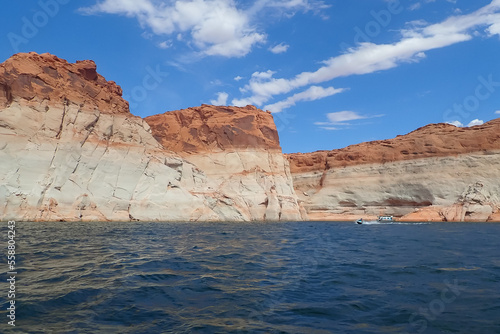 Boat on the Colorado River at Glen Canyon National Recreation Area with colorful sandstone formation in background