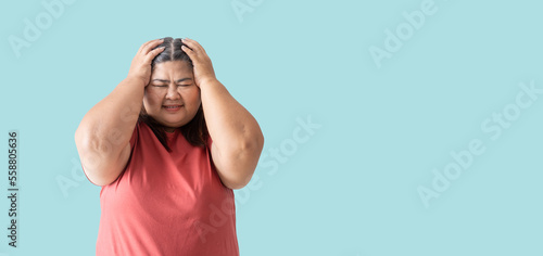 Asian fat woman, Fat girl , Chubby, overweight unhappy measuring her, isolated on blue background