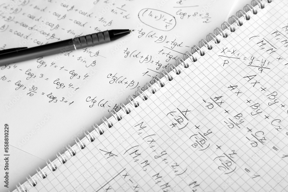 Paper with different mathematical formulas and pen, closeup Paper with different mathematical formulas and pen, closeup