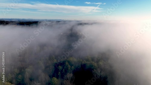 AERIAL THROUGH CLOUDS AT TREETOP LEVEL IN NEAR WILKESBORO NC, NORTH CAROLINA photo