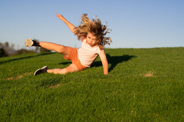 Kid runs through the spring grass and falling down on the ground in park. Moment of the fall down. Little child tripped and falls down. Fall risk for children. The moment of the fall. Clumsy kid.