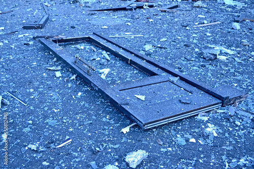 damaged wooden door frame and glass pieces on the street after missile attack in Kiev, Ukraine.