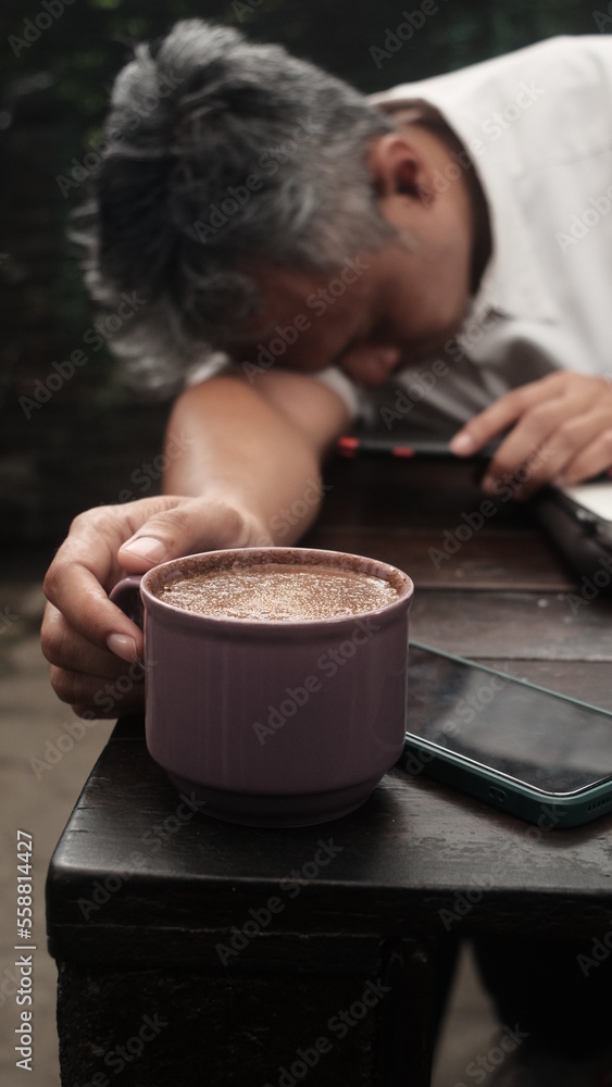 tired person try to drink coffee for push adrenaline back to work