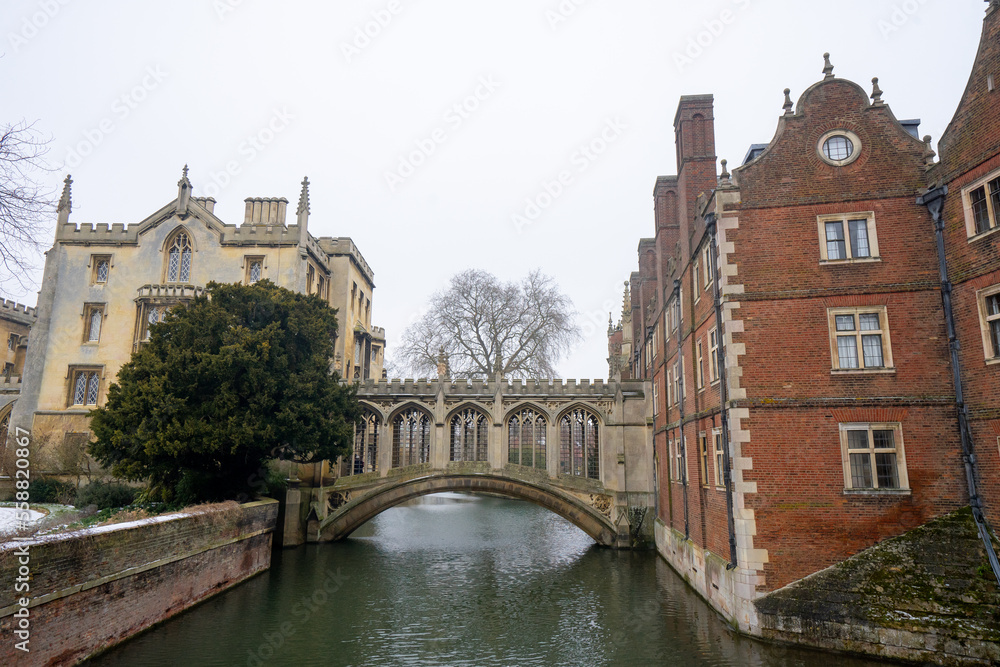 Naklejka premium Bridge of Sighs , Stone Bridge at at St John's College around University of Cambridge during winter snow at Cambridge , United Kingdom : 3 March 2018