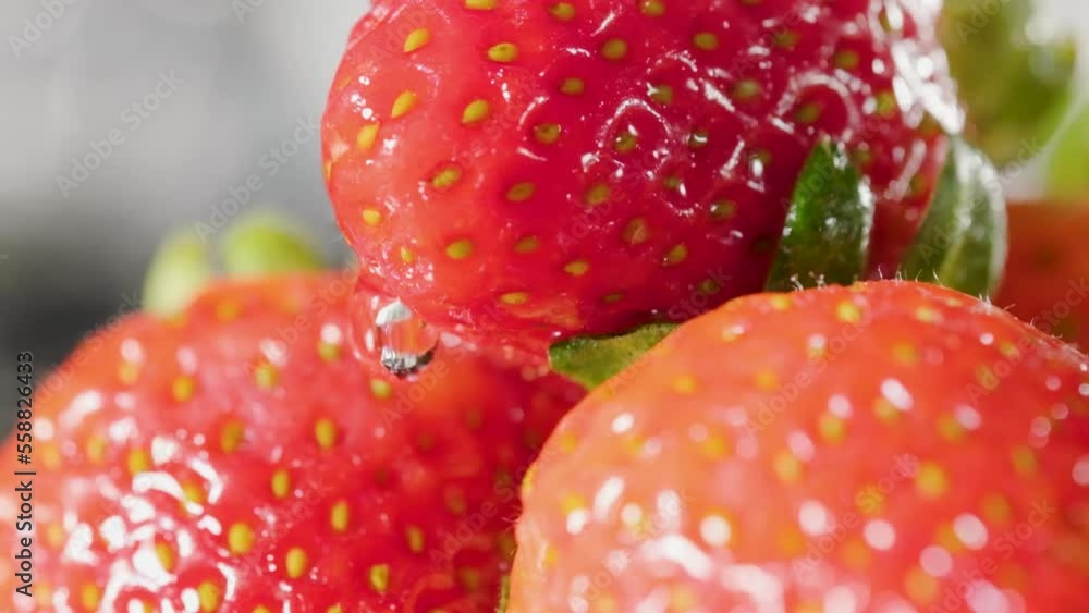 Water drop flowing along strawberries surface in Slow motion, Close-up Shot Water drop flowing along strawberries surface in Slow motion, Close-up Shot