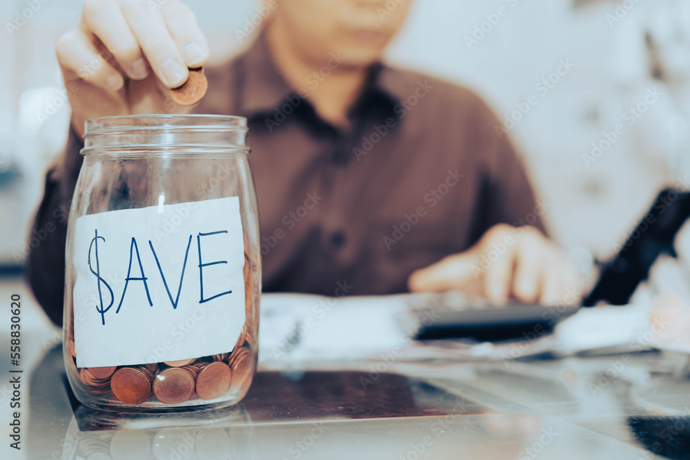 businessman putting coins in save symbol label jar for finance save salary economic account concept businessman putting coins in save symbol label jar for finance save salary economic account concept