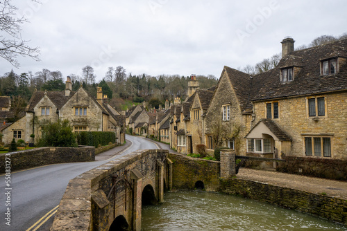 Castle Combe , Beautiful village in Cotwolds with old stone houses bridge and river during winter in Wiltshire , United Kingdom : 6 March 2018 photo