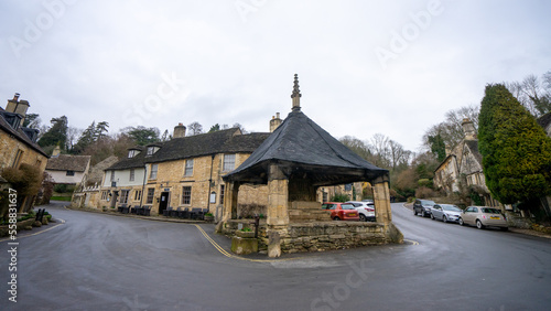 Castle Combe and The Market Cross , Beautiful village in Cotwolds old stone houses during winter in Wiltshire , United Kingdom : 6 March 2018