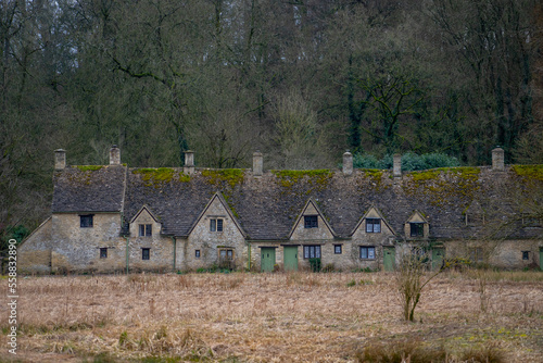 Fototapeta Naklejka Na Ścianę i Meble -  Arlington Row in Bibury , classic villages in Cotwolds wonderful stone buildings and river coln during winter cloudy day at Gloucestershire , United Kingdom : 6 March 2018