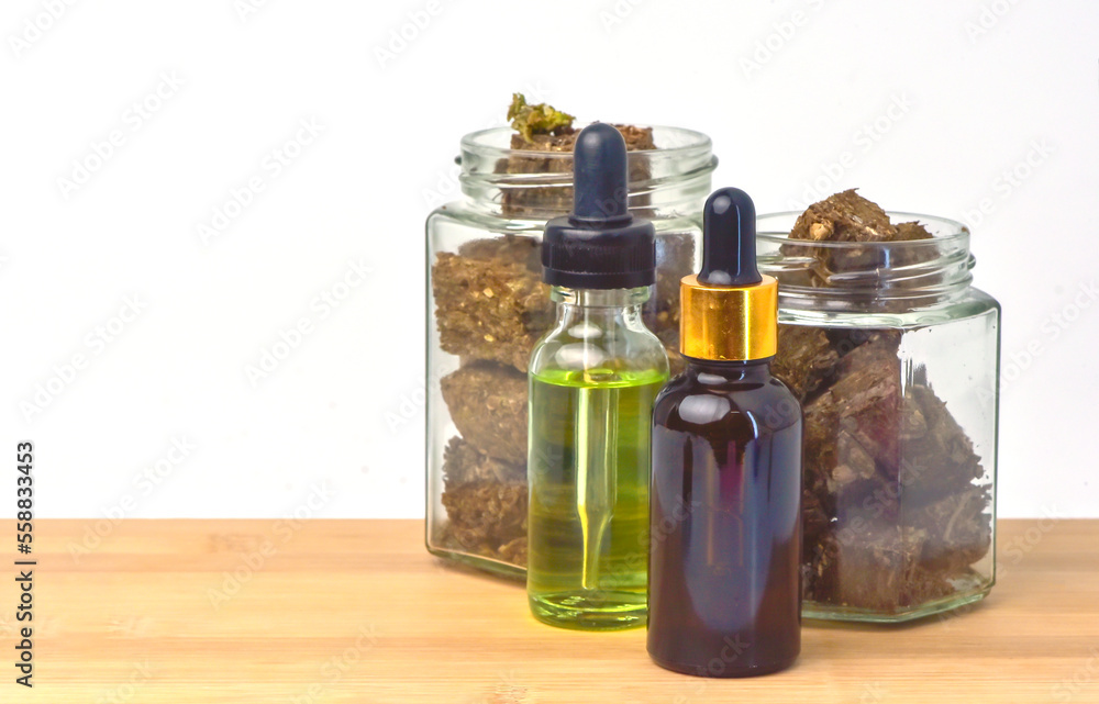 hemp oil bottle Jar of dried marijuana on wooden table, white background. CBD Hemp oil,hemp oil, Medical marijuana products including cannabis leaf, cbd and hash oil, alternative medicine hemp oil bottle Jar of dried marijuana on wooden table, white background. CBD Hemp oil,hemp oil, Medical marijuana products including cannabis leaf, cbd and hash oil, alternative medicine