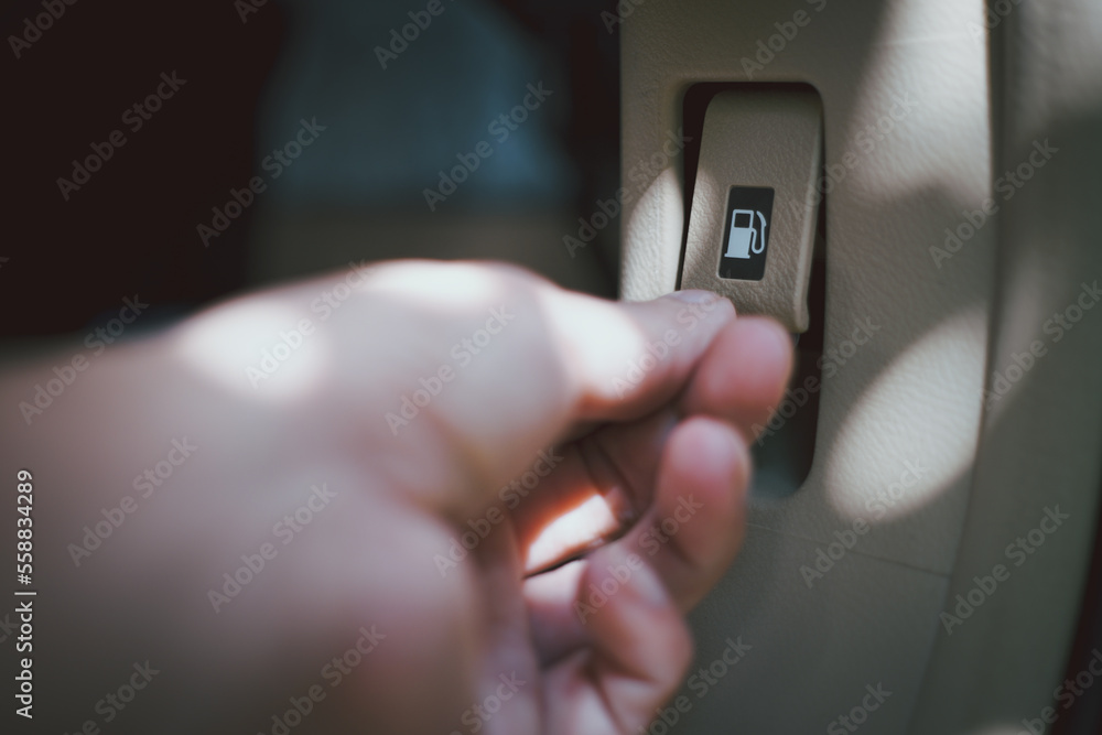 Close up shot of a car's. Open fuel tank lid in silvercar. Refueling a car at a fuel station Close up shot of a car's. Open fuel tank lid in silvercar. Refueling a car at a fuel station