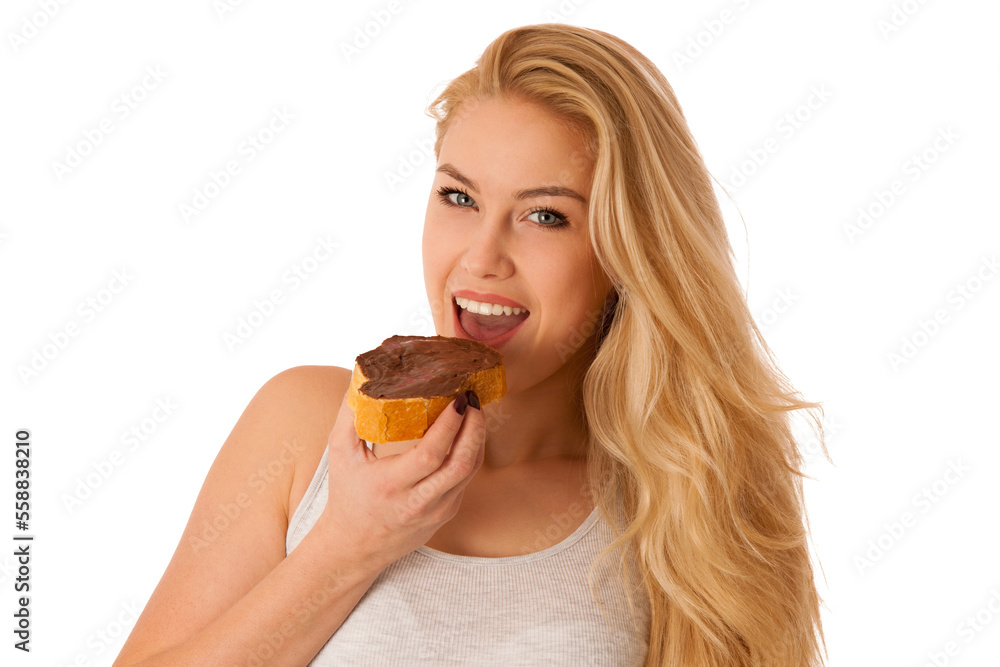 Young blond woman eating breakfast bread and nougat spread isolated over white background