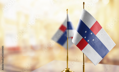 Small flags of the Netherlands Antilles on an abstract blurry background